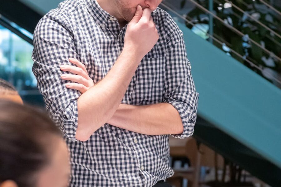 man holding his lips thinking